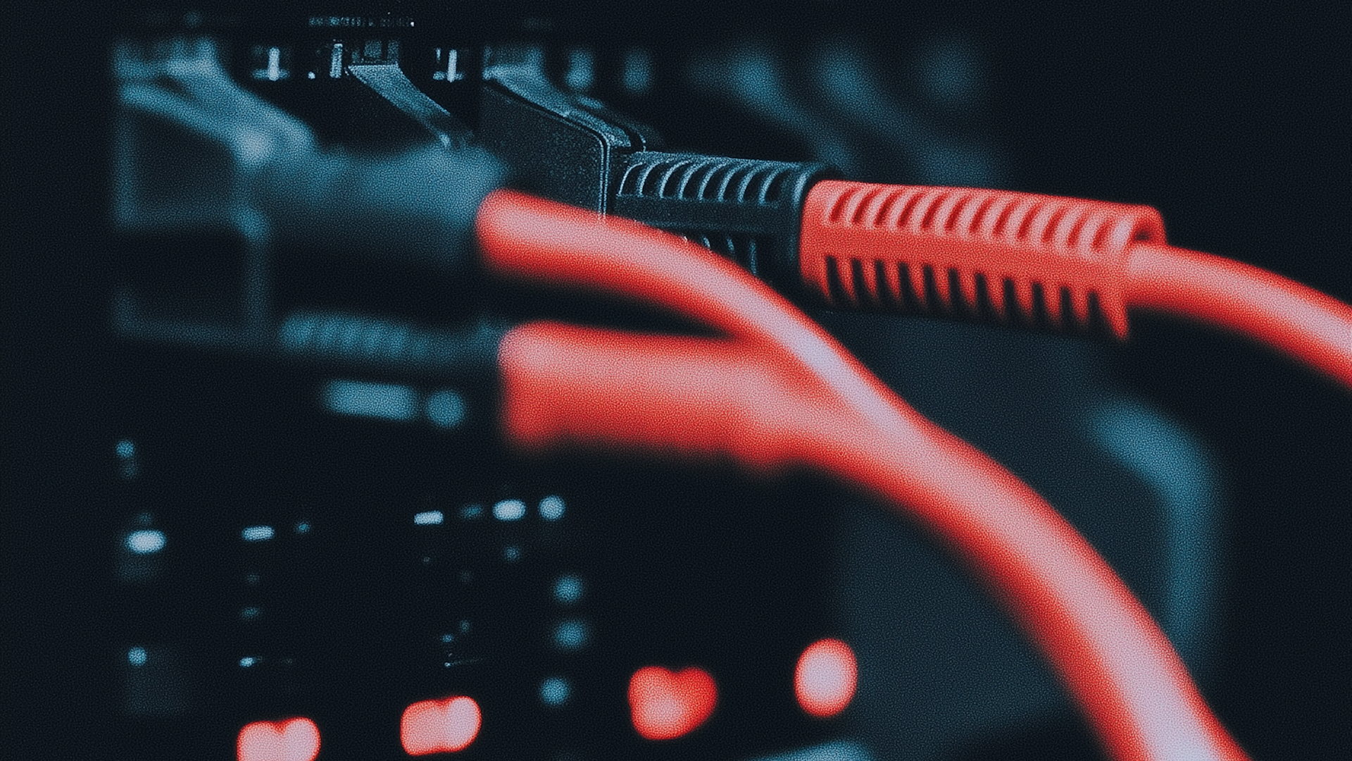 Neatly organized red network cables in a modern server rack, highlighting efficient cable management in a professional data center.