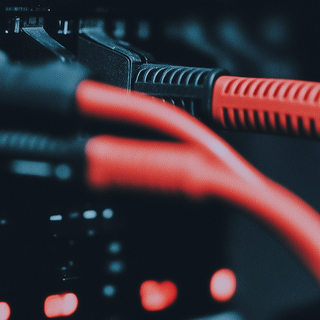 Neatly organized red network cables in a modern server rack, highlighting efficient cable management in a professional data center.