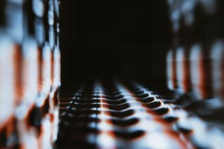 Abstract glowing waves in white and orange ripple