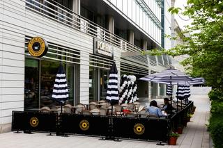 Espresso being poured through a machine, close up photograph.