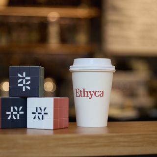 Rubiks cubes with Ethyca logo and Ethyca branded cup.