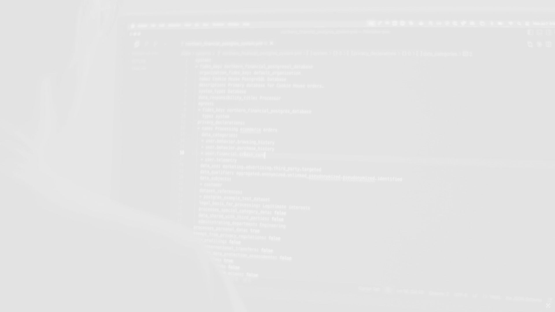 A person sitting in front of a computer screen with code, in black and white.