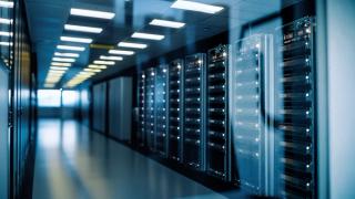 A modern data center with rows of illuminated server racks on the right. Reflective surfaces and bright lighting convey a high-tech atmosphere.