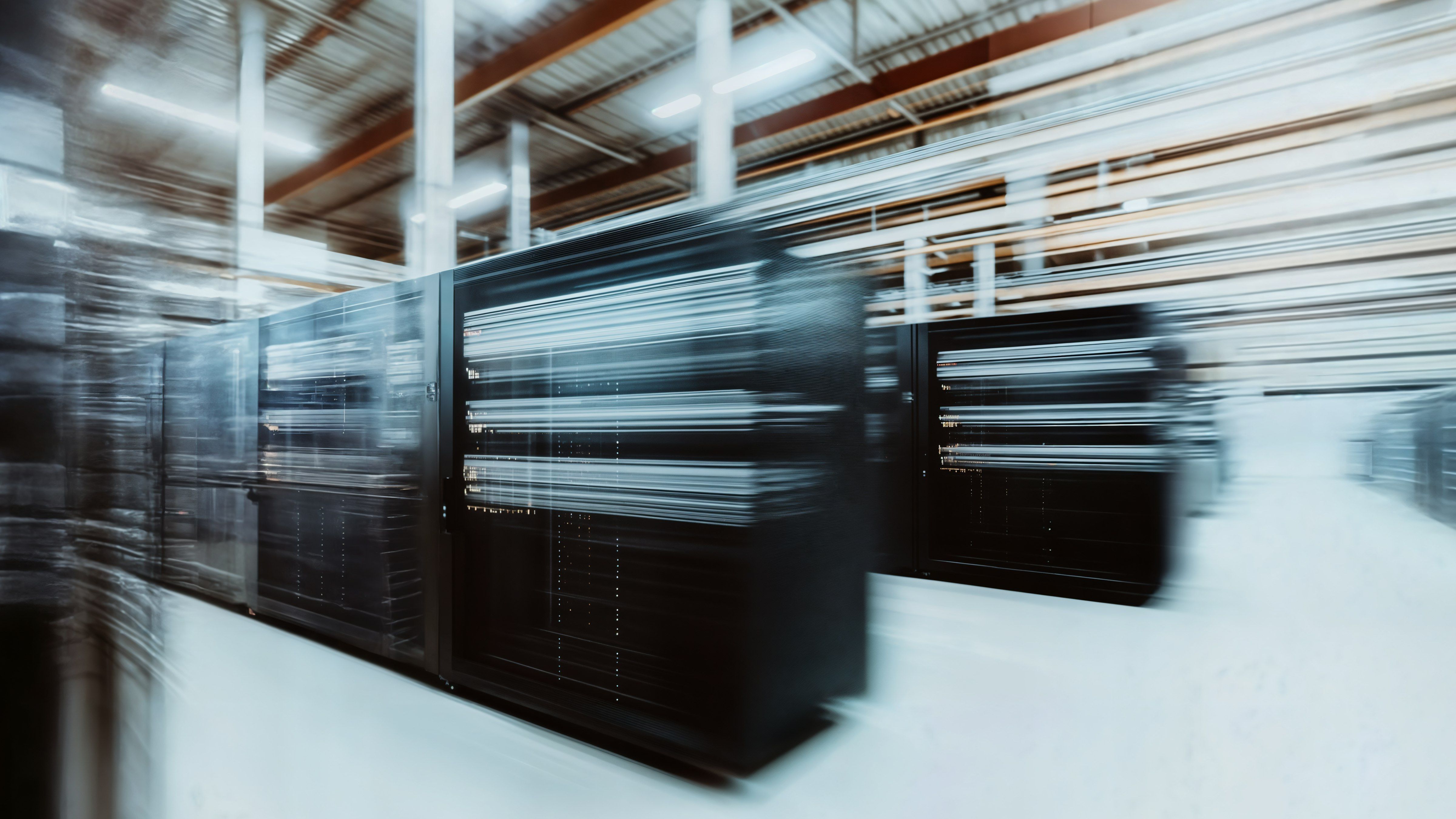 Blurred motion shot of server racks in a data center, highlighting speed and technology in a modern industrial setting