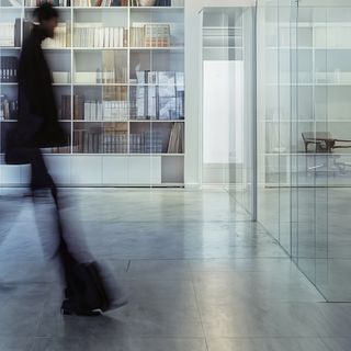 Blurred figure walking in a modern office