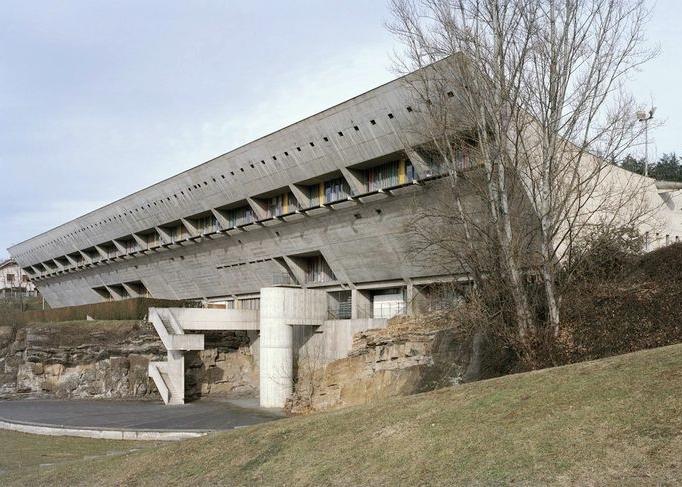 The sloping concrete volume of the Maison de la Culture in Firminy with its coloured windows, set into the hillside