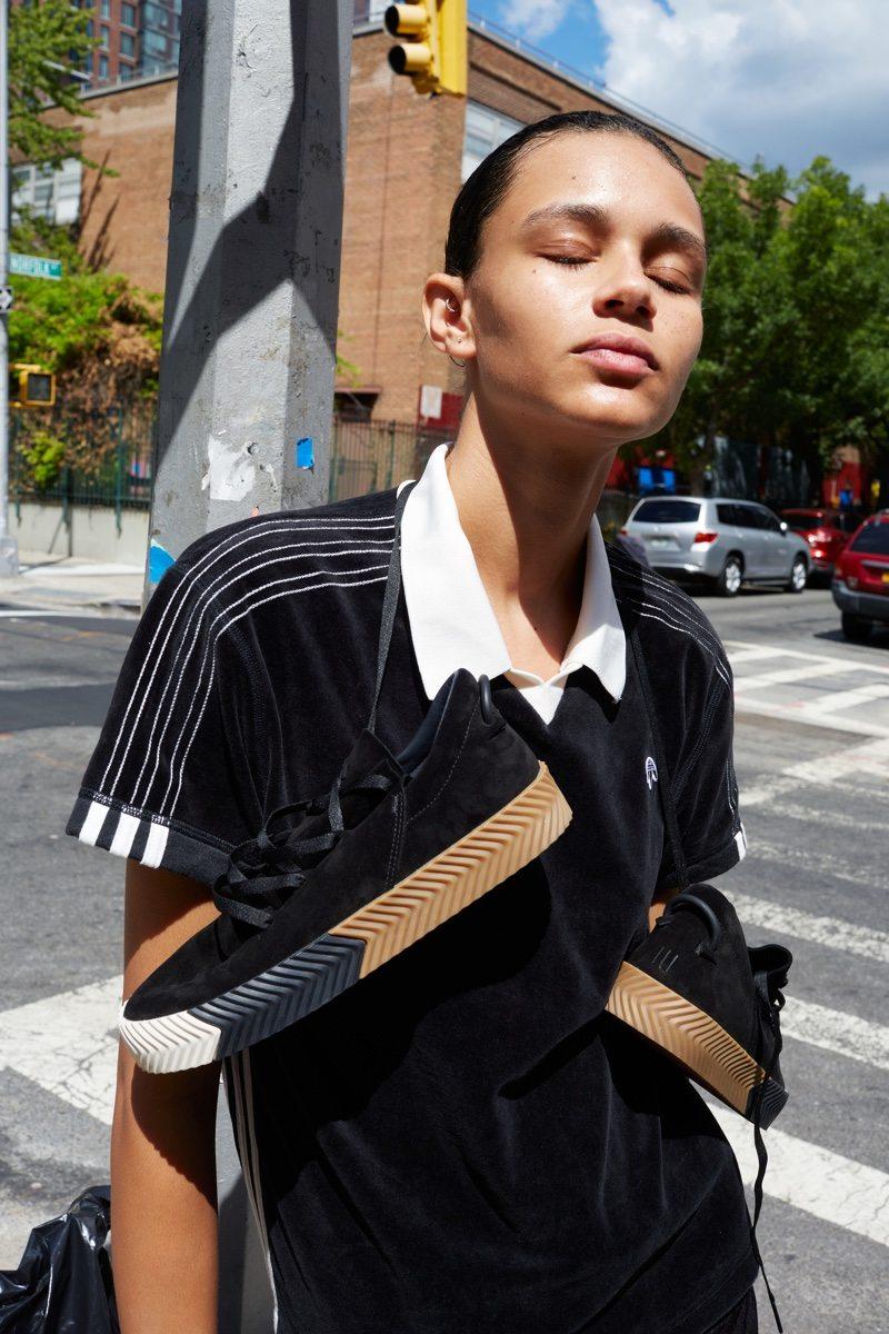 A model wearing sneakers from the Adidas Originals x Alexander Wang collaboration, photographed on the street