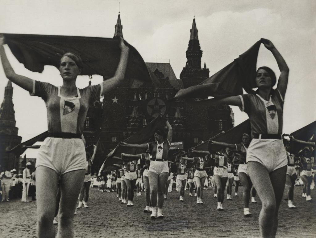 A physical-culture parade on Red Square: young women wave flags in front of the State Historical Museum