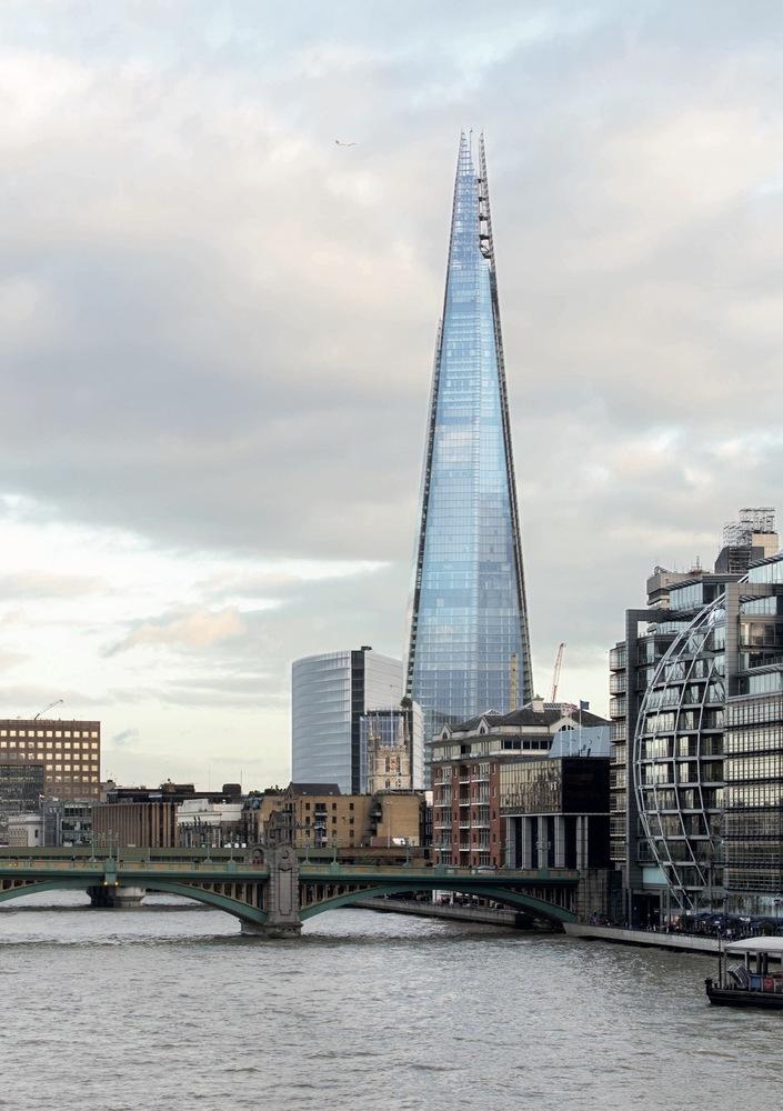 The Shard skyscraper in London, with its glass spire above the Thames embankment and bridge