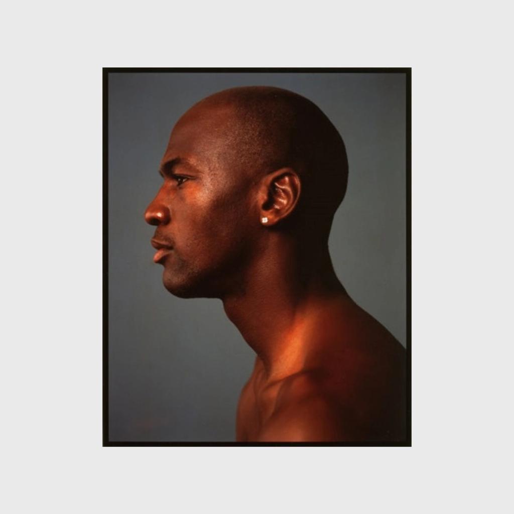 A colour profile portrait of a bare-chested athlete with a shaved head