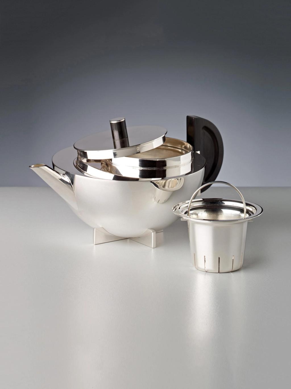 Marianne Brandt's silver teapot with a dark wooden handle and tea strainer