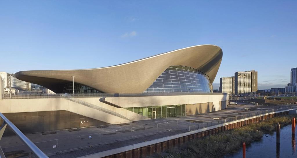 The London Aquatics Centre with its undulating curved roof set against the sky
