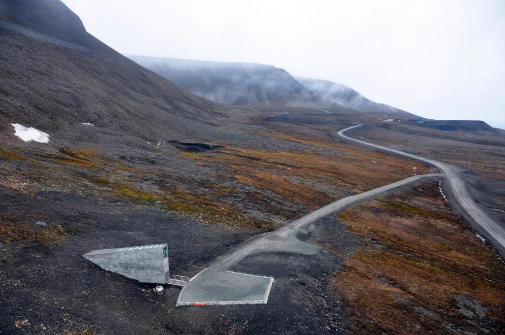 The low concrete portal of the vault on a mountainside beside a winding dirt road