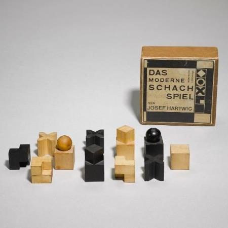 Josef Hartwig's chess pieces in light and dark wood, shown alongside their original box