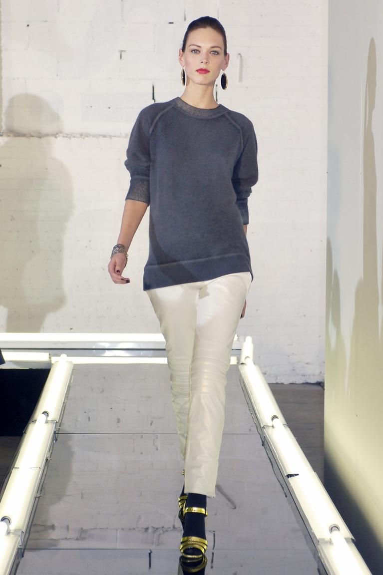A model in a grey sweater and white leather trousers at an Alexander Wang show