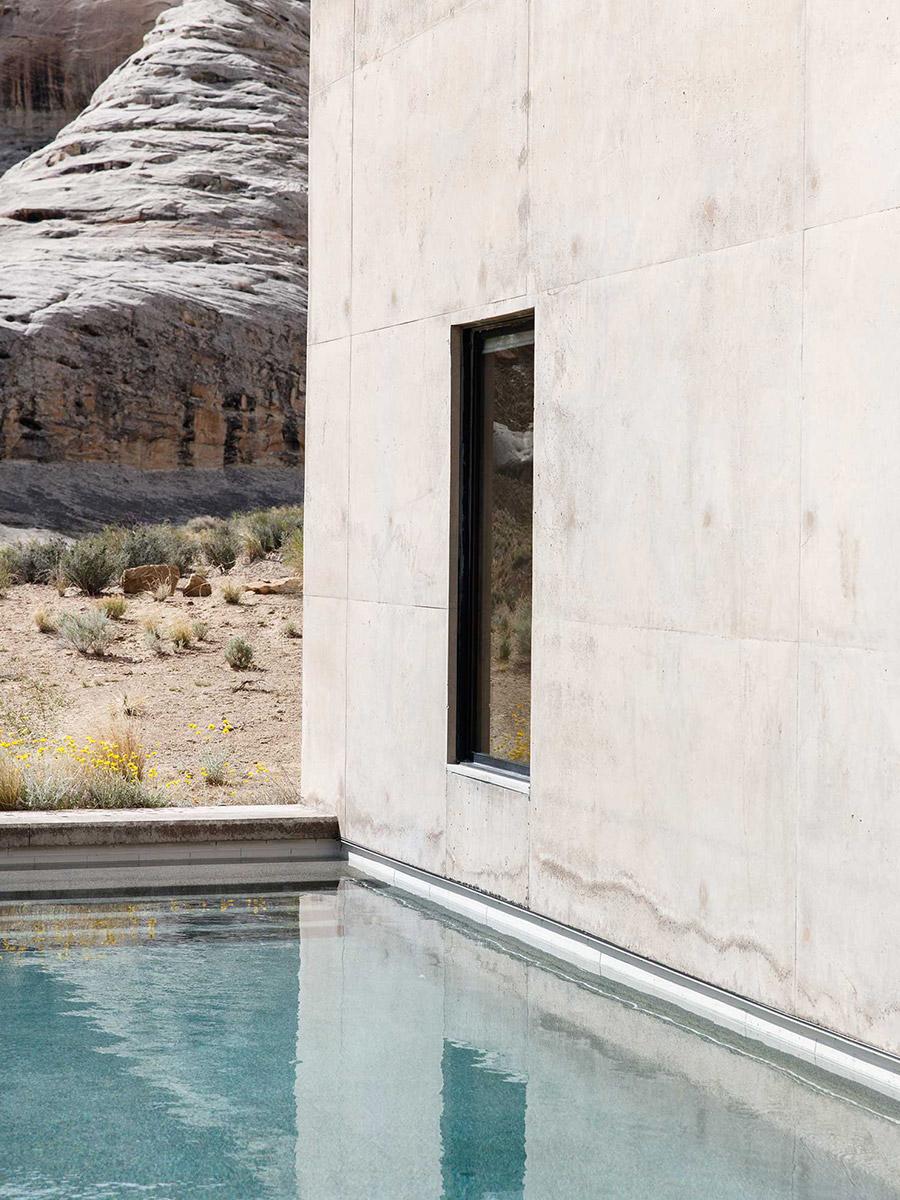 The pool running along the concrete wall of the Amangiri hotel, with views of the sandstone rocks of the Utah desert