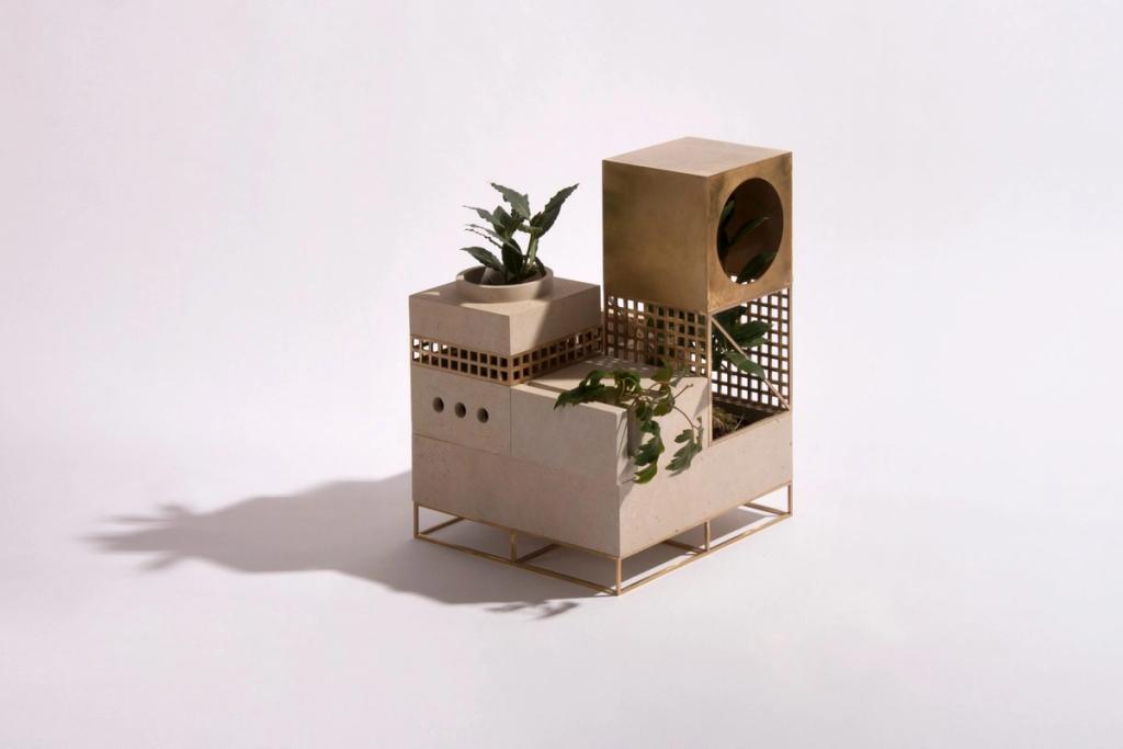 A modular stone-and-brass planter object with houseplants, designed by Maxim Shcherbakov