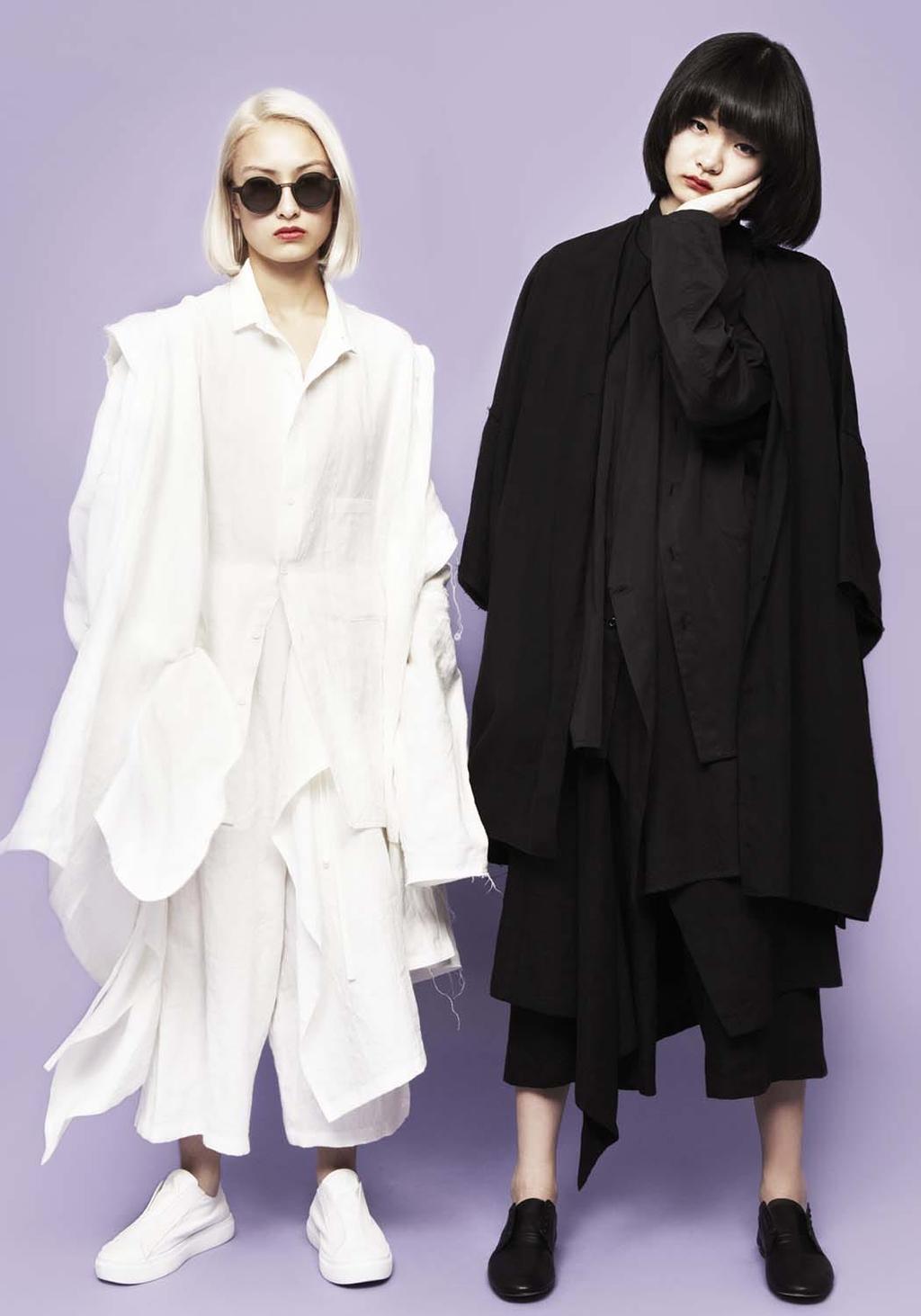 Two models in oversized looks: an all-white ensemble and an all-black ensemble