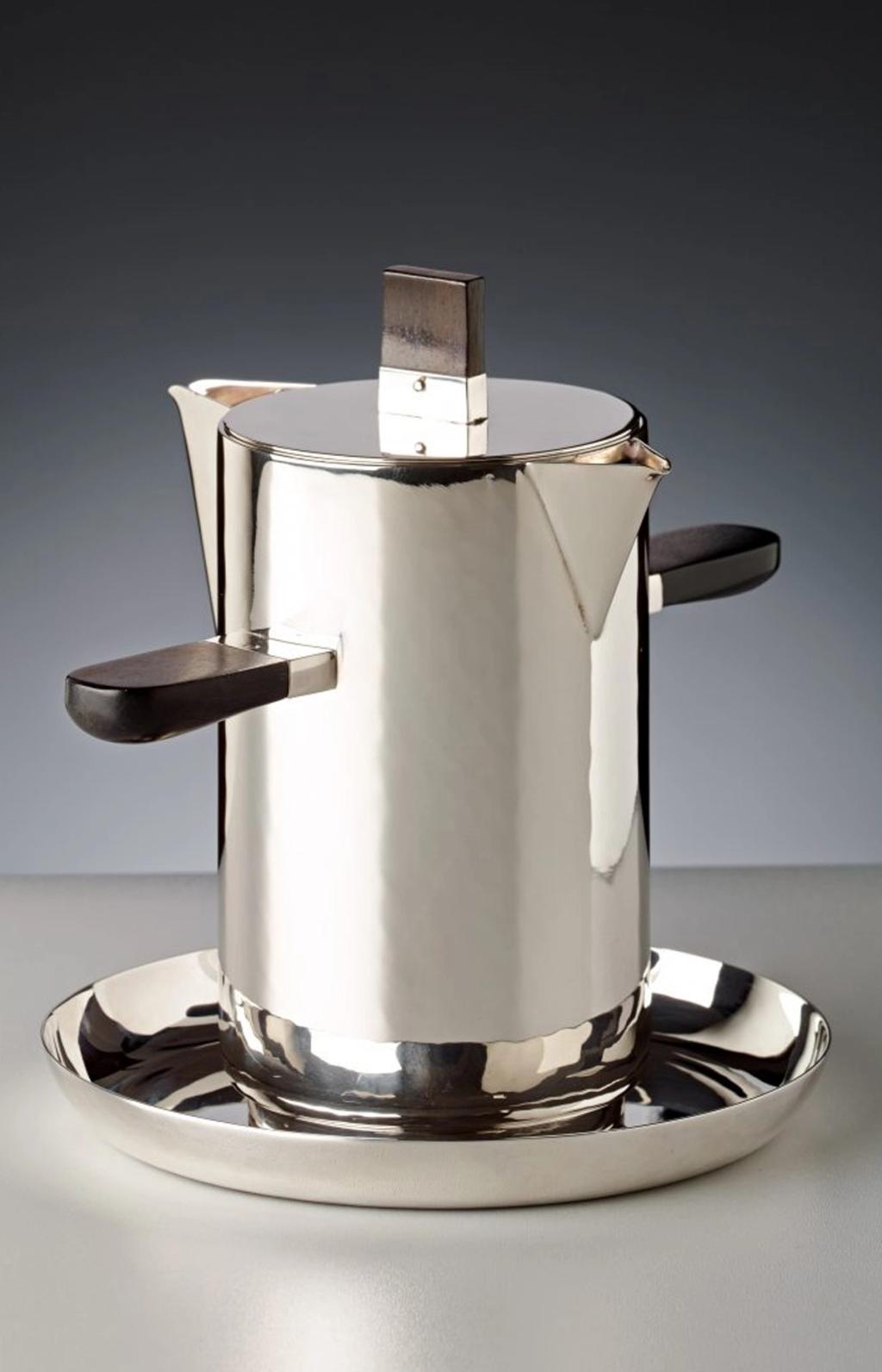 Wilhelm Wagenfeld's silver coffee pot with dark wooden handles, on a round tray