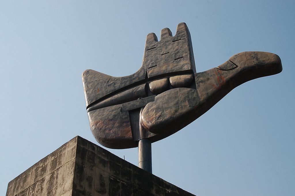The Open Hand Monument in Chandigarh against an open sky