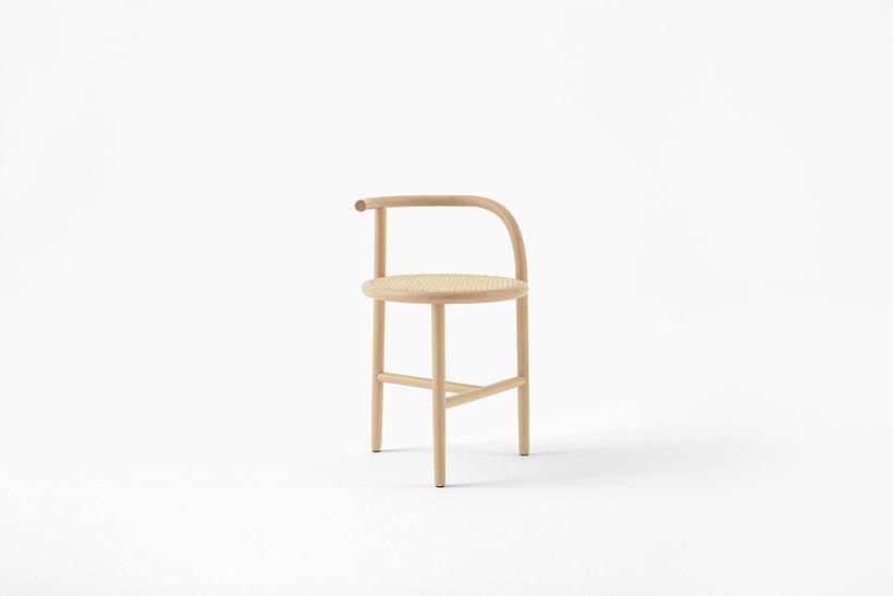Wooden chair with a curved back-armrest and a woven seat