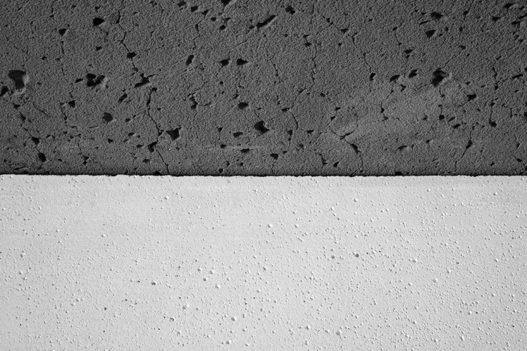 The contrast between a dark porous and a light smooth concrete surface on the facade