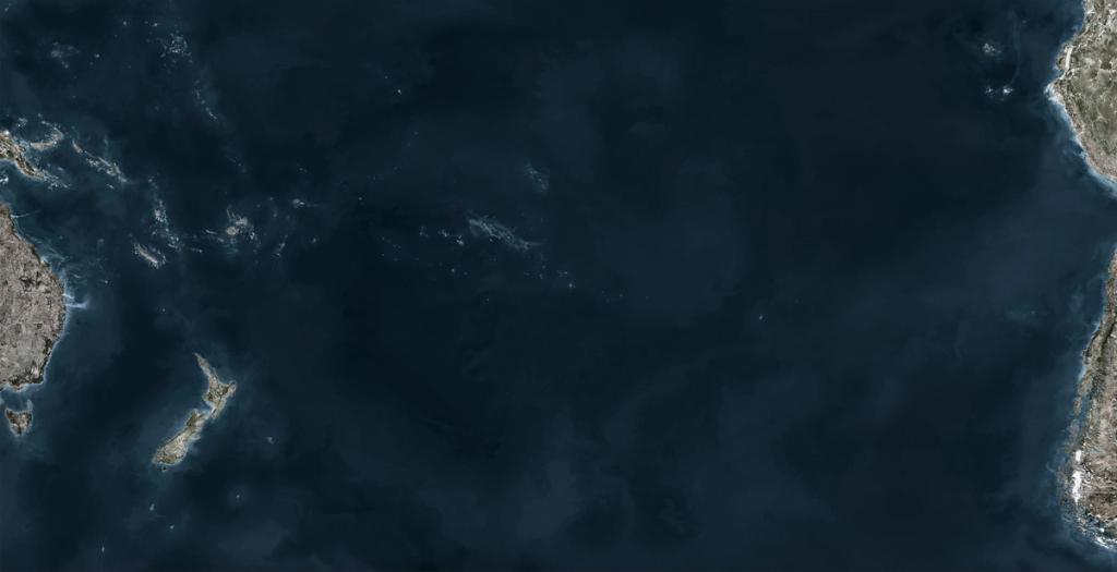 Satellite image of a dark ocean with fragments of land along the edges of a horizontal frame