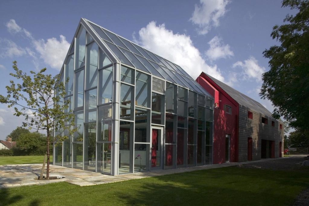 The glazed pitched-roof extension of the dRMM Sliding House on a sunny day