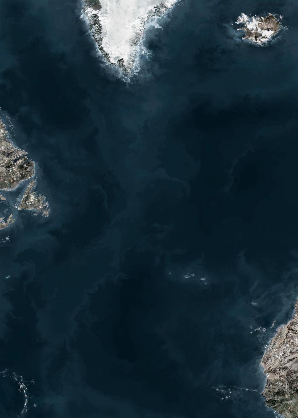 Satellite image of the ocean with snow-covered Greenland and Iceland in the upper portion of the frame