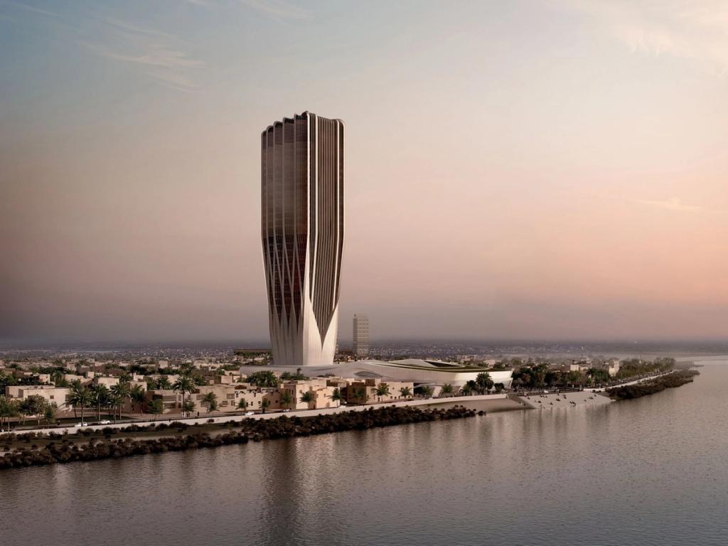 A ribbed tower on a riverbank at pink dusk — a high-rise project