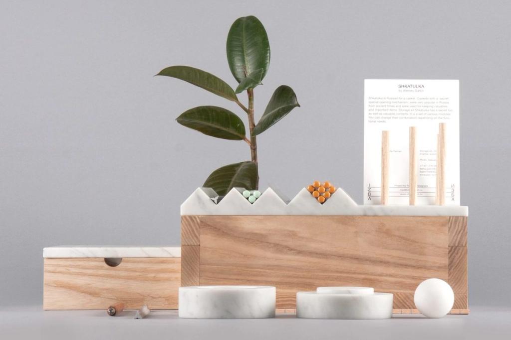 The Shkatulka wooden box with a serrated marble lid, a fig plant and marble bowls alongside