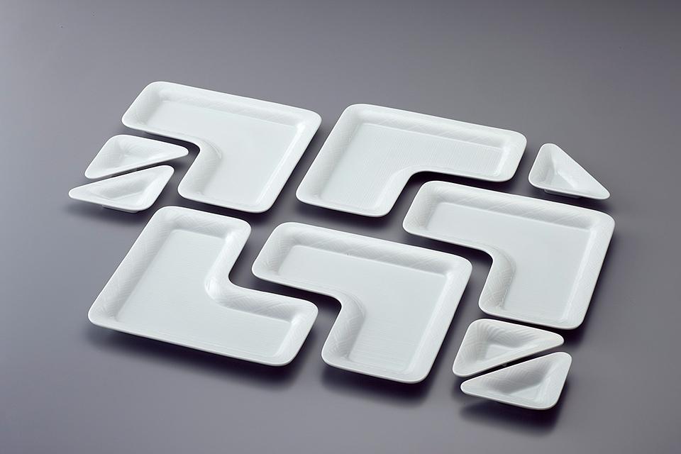 A set of white porcelain plates in an angular L-shaped form