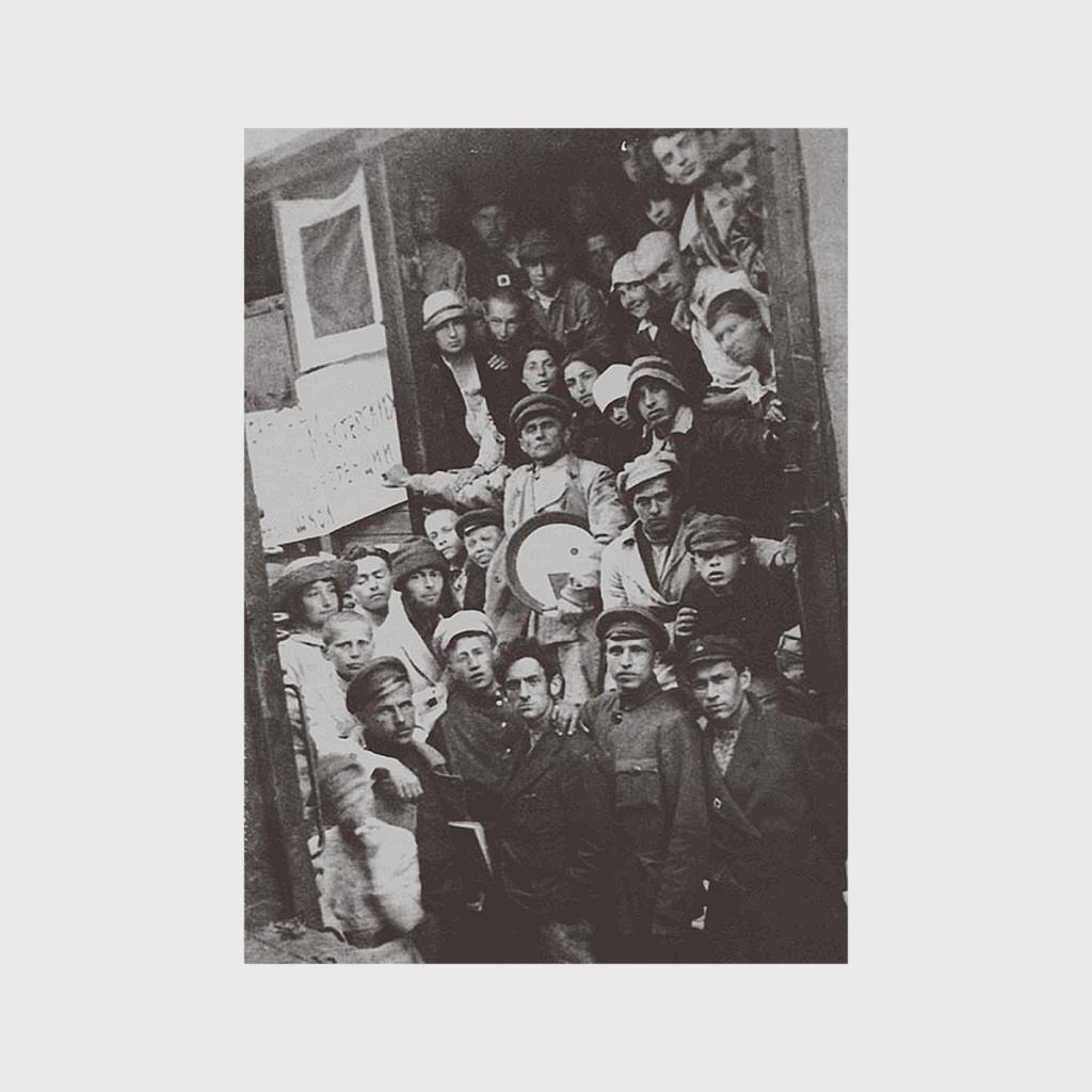 An old black-and-white photograph of UNOVIS members crowded in a doorway, Vitebsk