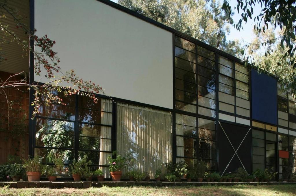 The glass facade of the Eames House with its steel frame and coloured panels