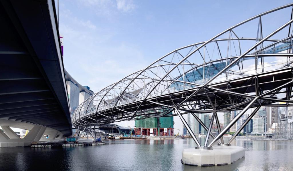 The steel skeleton of the Helix Bridge, shaped like a DNA strand, spanning the waters of Marina Bay in Singapore