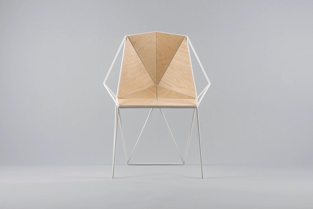 An armchair with a geometric plywood back and a slender white metal frame, designed by Maxim Shcherbakov