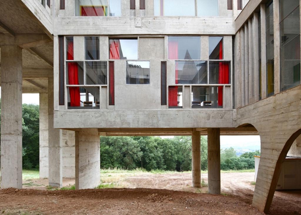 The concrete volume of Couvent Sainte-Marie de La Tourette with coloured stained-glass windows, raised on pilotis