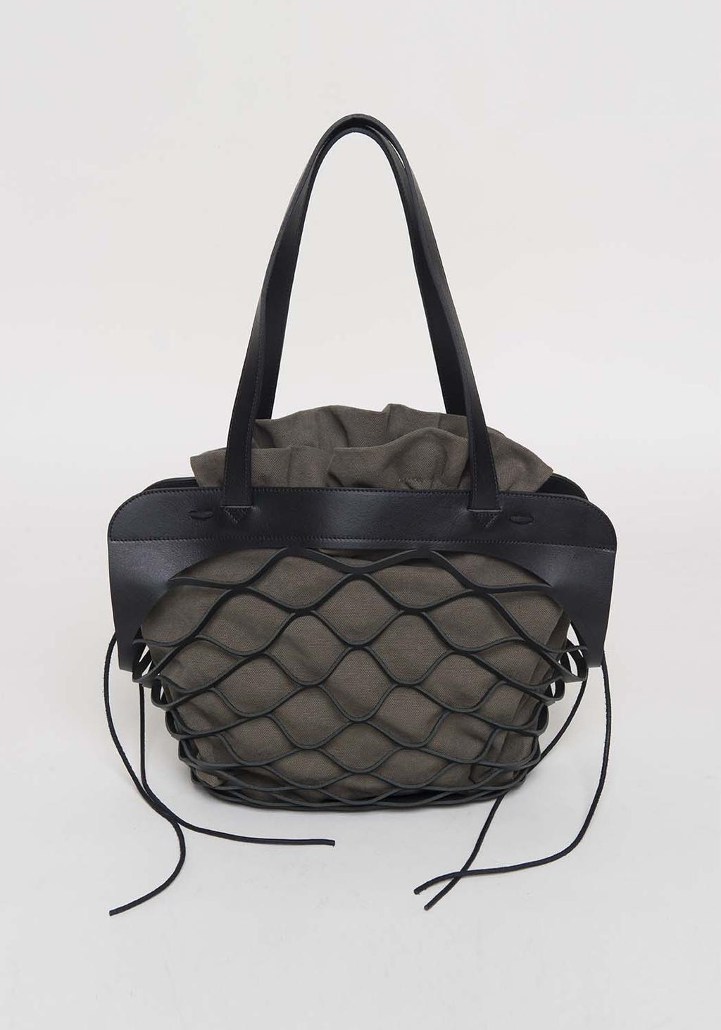 A khaki fabric tote bag with a black leather mesh overlay and ties