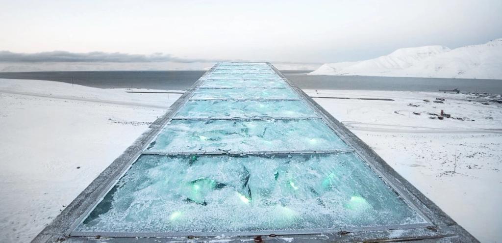 Aerial view of the vault's sloping roof with illuminated glass panels set among the snow-covered tundra