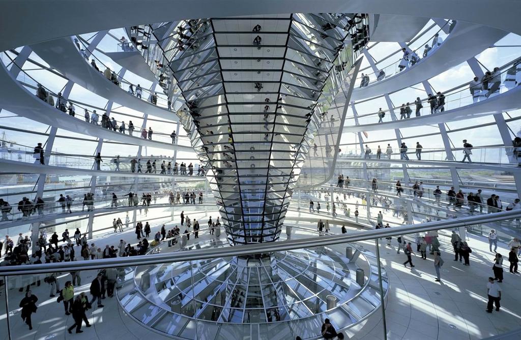 The interior of the Reichstag dome with its two spiral ramps and visitors