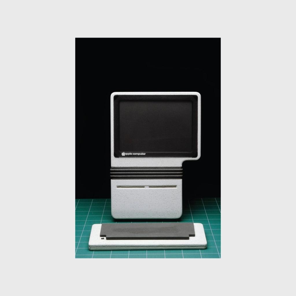 A conceptual white Apple Computer all-in-one on a green cutting mat