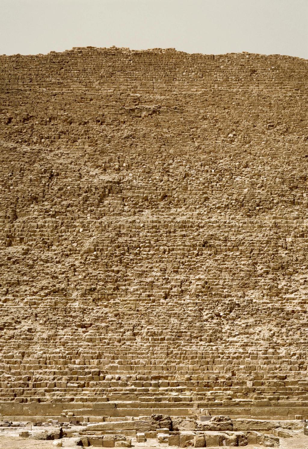 Close-up of the stone masonry of an Egyptian pyramid, with rough, stepped blocks