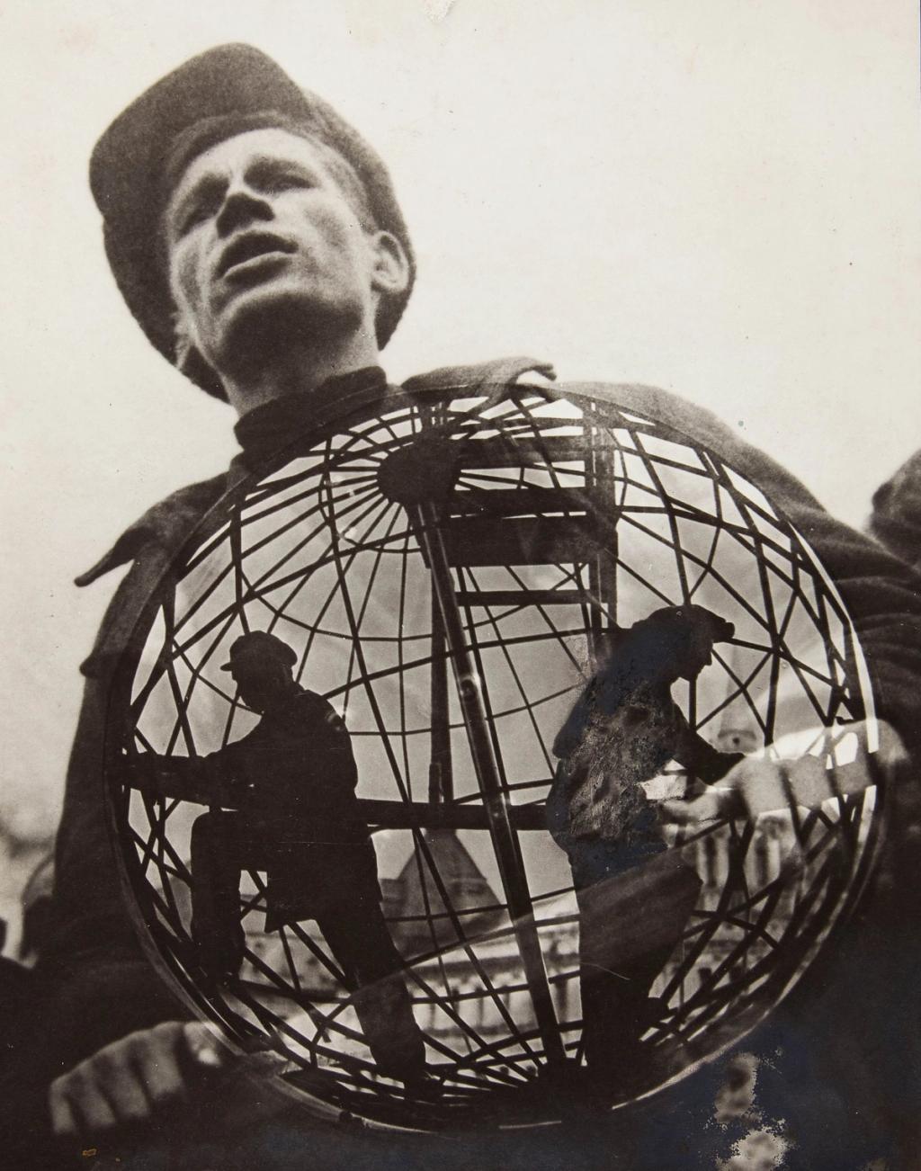 Photomontage: a young man in a cap behind a wire sphere-globe with silhouettes of workers inside