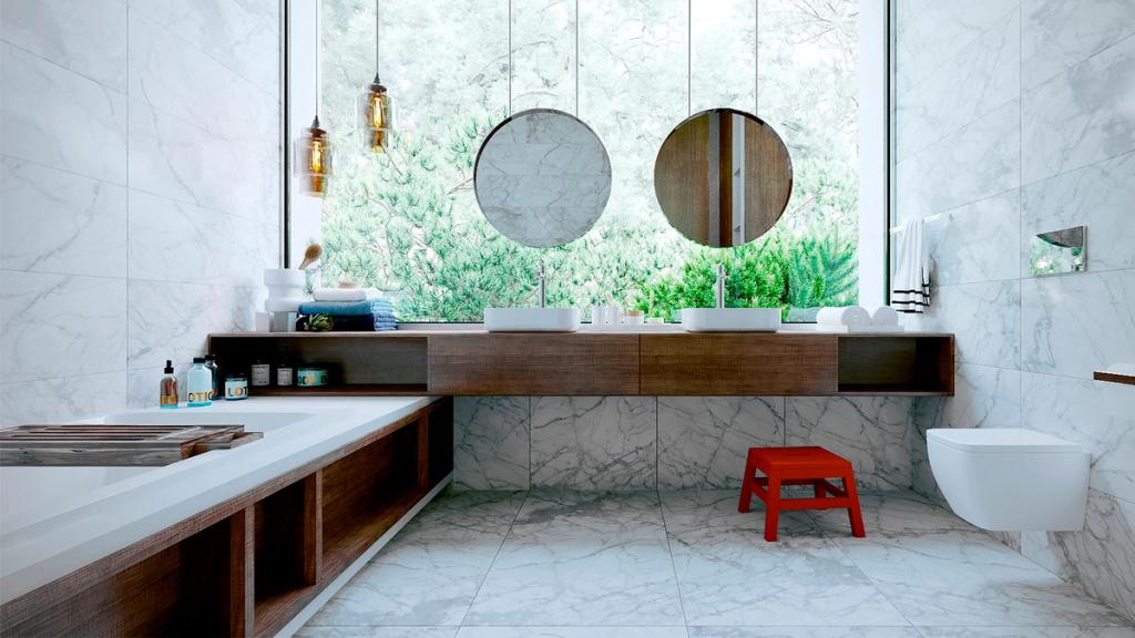Bathroom with marble finishes, two round mirrors and a panoramic window looking out onto greenery