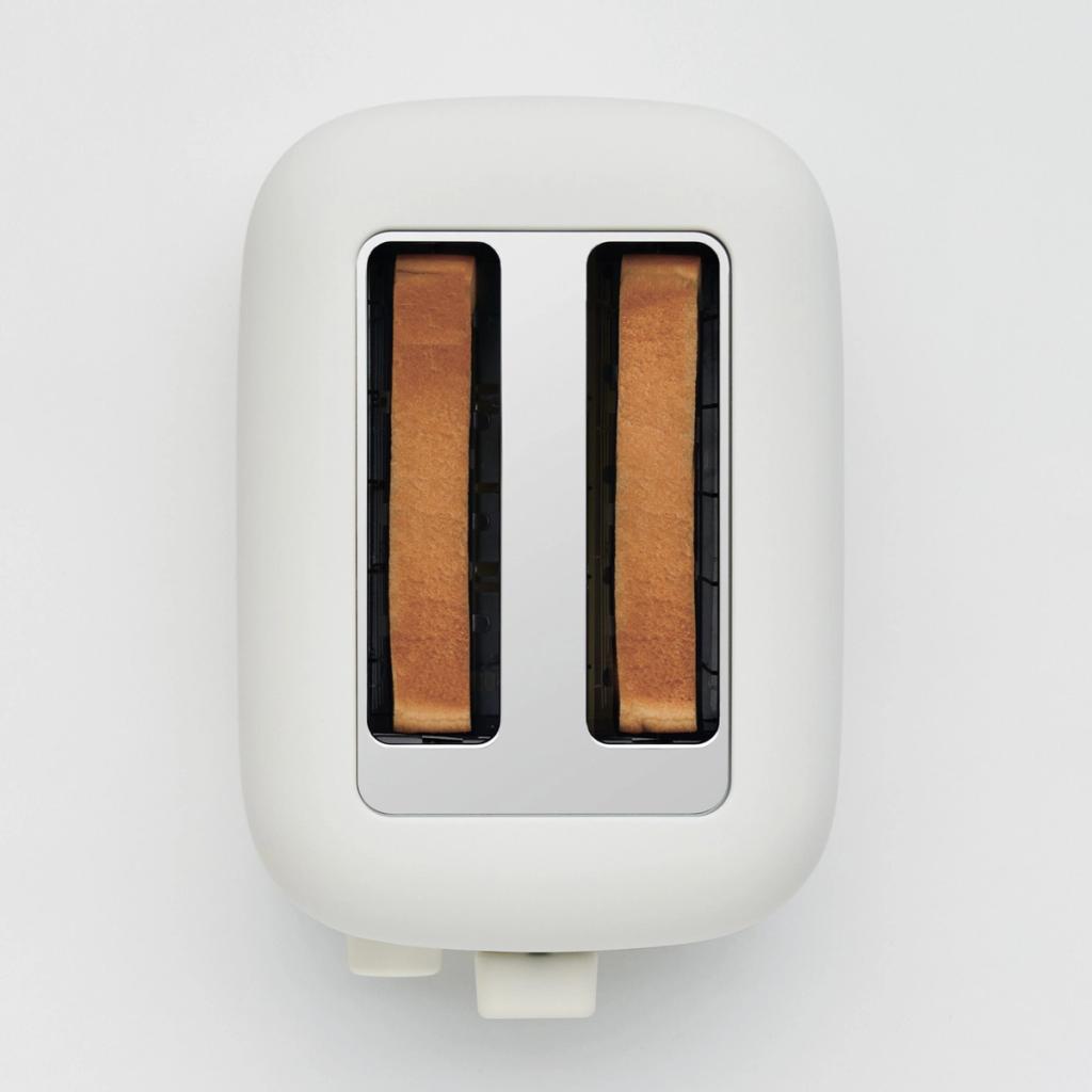 A white toaster seen from above, with toasted slices of bread in both slots