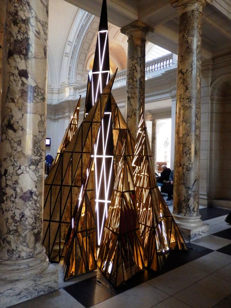 Gareth Pugh's luminous golden pyramidal installation with an illuminated cross