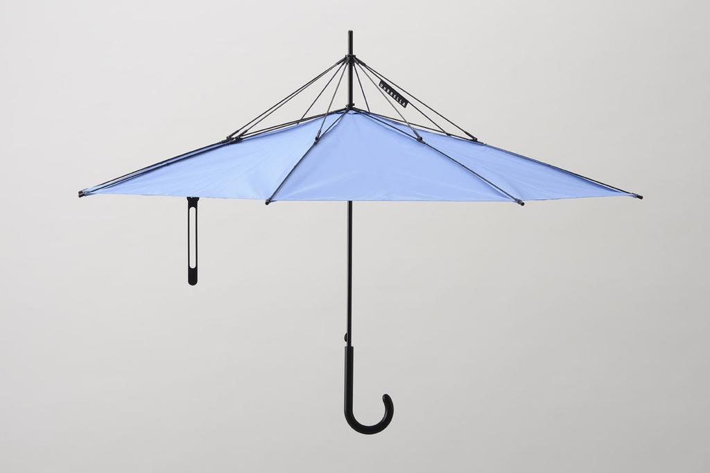 A blue umbrella turned upside down with its canopy facing up and a curved hook handle