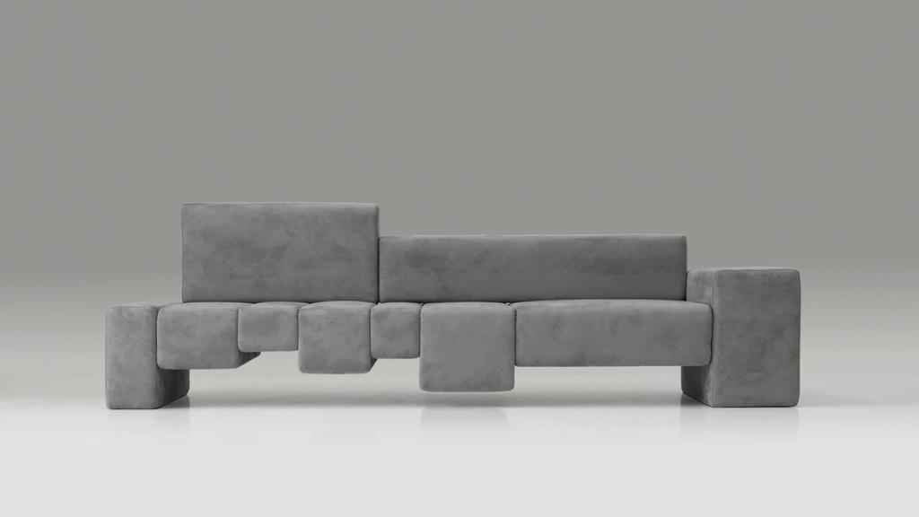 A grey modular sofa composed of soft blocks of varying heights, designed by Dima Loginov