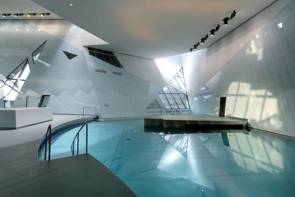 The indoor pool of the Westside water park, with angular white walls and triangular windows