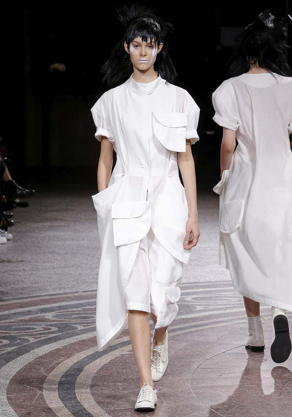 A white dress with large patch pockets on the Yohji Yamamoto runway